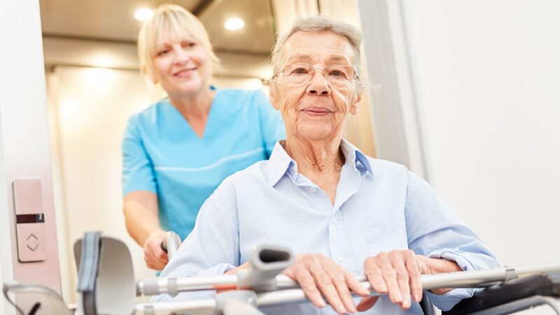 elderly patient in wheelchair and nurse