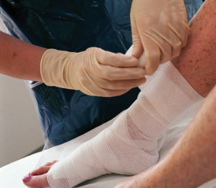 Person's ankle being bandaged