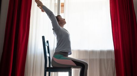 woman on chair doing yoga