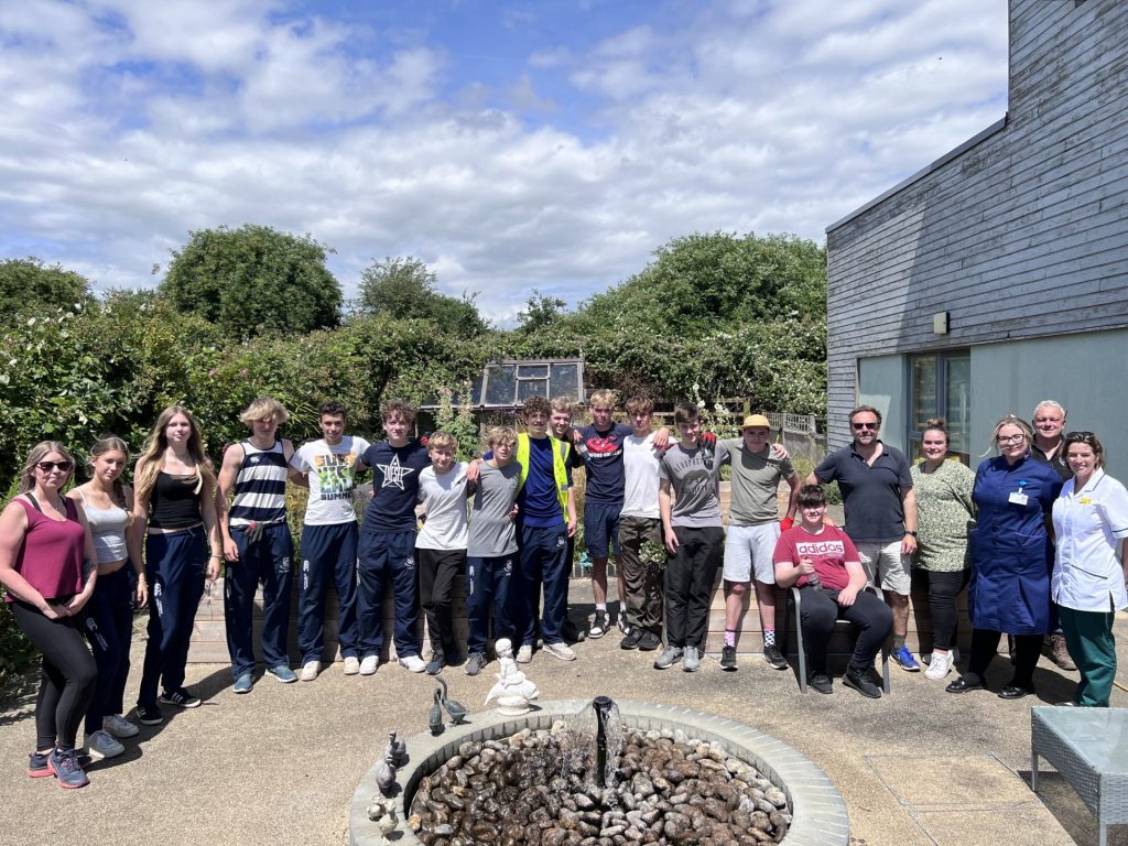 Volunteers and staff gathered in the garden at Donald Wilson House