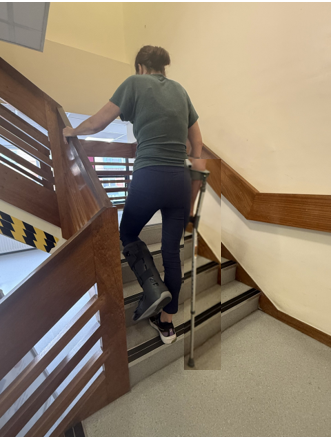 Going upstairs holding crutch