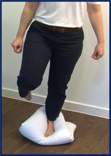 standing on one leg on a pillow