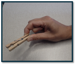 A hand holding a clothespin