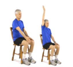 A person sitting in a chair and lifting their hand above their head