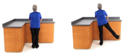 Woman holding onto the table and moving their leg to side to side.
