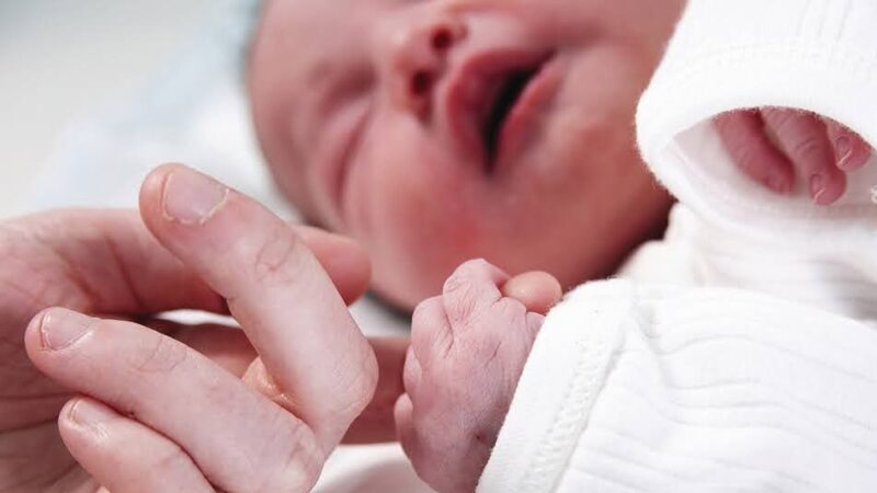 Baby holding finger