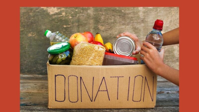 Box with 'Donation' written on the side filled with food donations