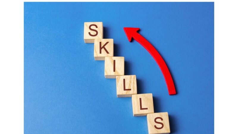 Graphic of letter tiles spelling the word Skills and a red arrow alongside it.