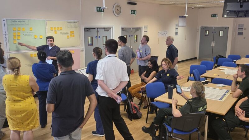 Group working around whiteboard