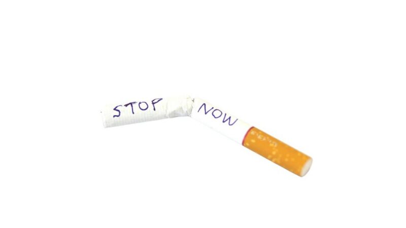 Broken cigarette with the words 'Stop Smoking' written on it